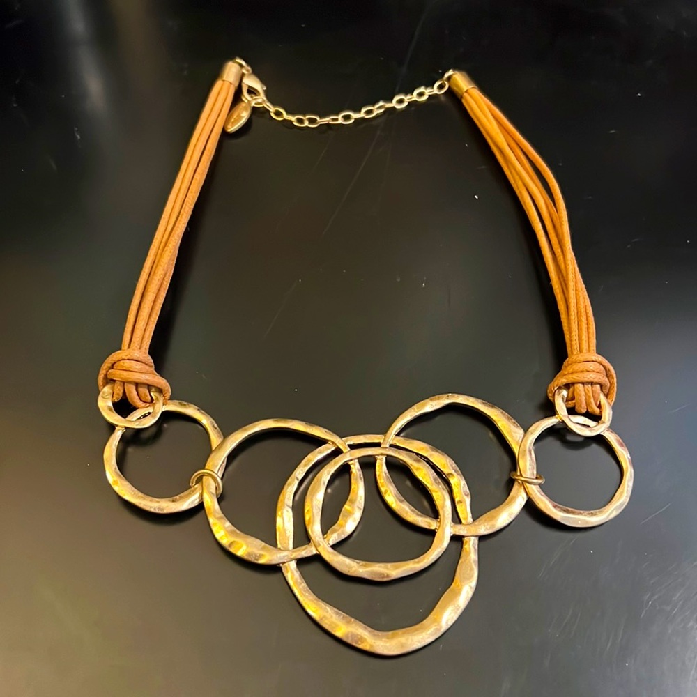 Gold tone hammered metal and leather necklace